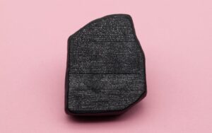Large black stone against a pink background to illustrate check Rosetta After Upgrading to macOS 27 Golden Gate | AustinMacWorks.com